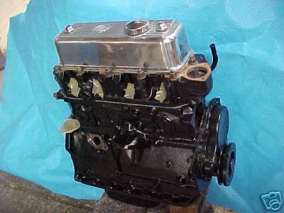 Rebuilt classic MG engine on a blue workshop bench